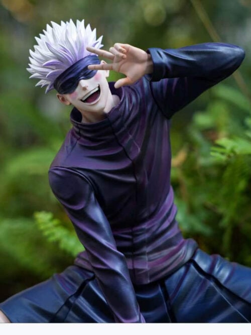 Medium view of Firefly Studio's Satoru Gojo Vol. 02 statue highlighting the purple-shaded creases of his dark jacket, pleated uniform skirt, blushed grin beneath his blindfold, and raised peace sign.
