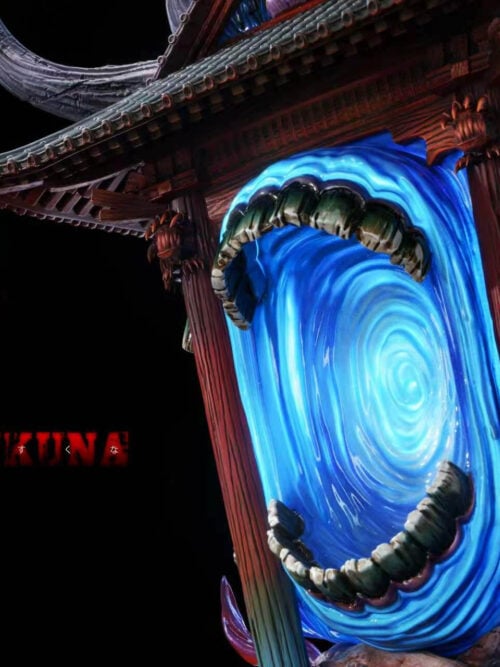 Close-up of the horned wooden shrine accessory from the RealWorld Studio Ryomen Sukuna statue showing swirling blue light-up vortexes framed by sculpted fanged jaws and hanging skulls.