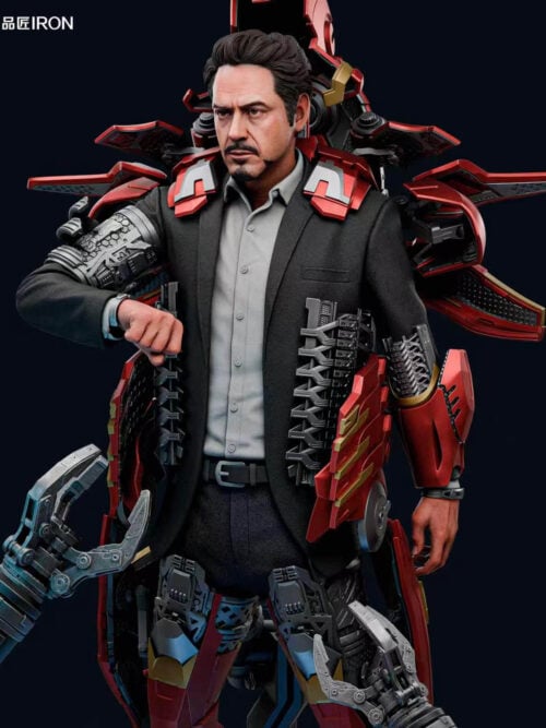 Front upper-body close-up of the Tony Stark MQ70 Mark VII statue showing his portrait, dark suit jacket over a grey shirt, mechanical torso ribs, silver right upper-arm mechanism, red-and-gold left gauntlet, and open helmet assembly.
