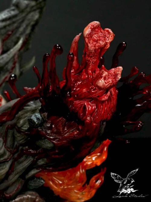 Close-up of the display base showing a severed creature limb with exposed bone surrounded by translucent red blood splashes and orange flame effects.