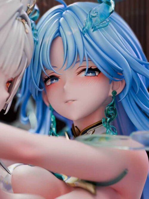 Close-up render centered on the blue-haired figure’s face, showing layered blue hair, a translucent blue hair ornament, blue eyes, and a green dangling earring. Part of the white-haired figure appears at the left edge.