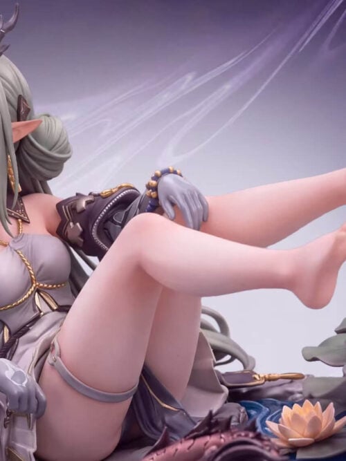 Front-right angle of the Si statue seated with her bare legs raised above lotus leaves and a blooming water lily, showing her gold-trimmed halter top, grey thigh strap, and patterned gloves.
