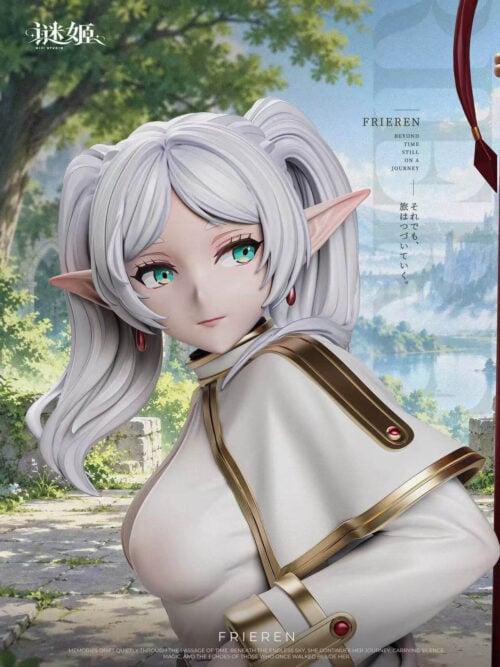 Close-up promotional view of the Frieren figure’s face and upper body, showing silver-white twin-tail hair, pointed ears, green eyes, red earrings and a white high-collared coat with gold trim and a red accent. Part of the red staff appears at the right edge, with trees and a path behind and MiJi Studio branding.