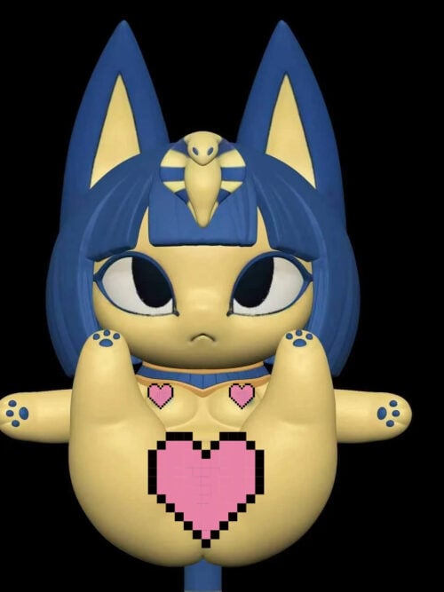 Front view of a cream Ankha cat figure on a black background, with a navy bob, tall pointed ears, yellow cobra headpiece, blue collar, outstretched limbs with blue paw pads, and pink pixel hearts on the chest and belly.
