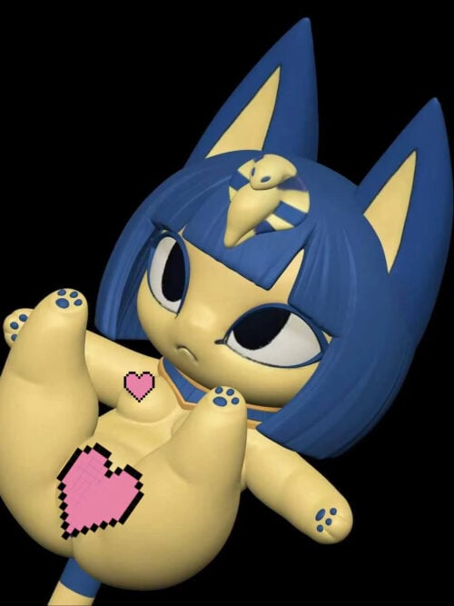 Angled view of the same cream Ankha cat figure on a black background, showing the cobra headpiece, navy hair, raised hind paw with blue pads, an outstretched forelimb, and pink pixel hearts on the torso.