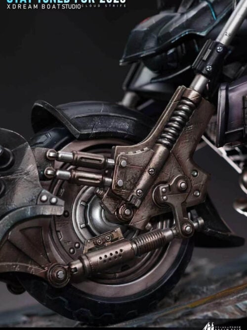 Close-up of the motorcycle front wheel hub, dual suspension springs, and weathered mechanical linkages on the Cloud Strife statue