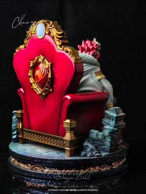 Rear angled view of the Natsu Dragneel throne statue showing the gold-framed red Fairy Tail crest on the chair back and stone ruins
