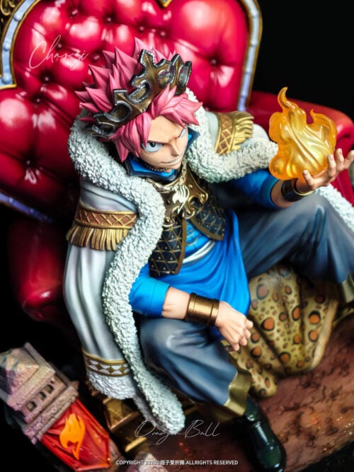 High-angle close-up of Natsu Dragneel wearing a crown and fur-trimmed cape while holding a translucent orange flame