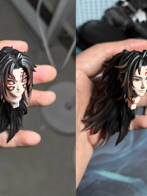 Side-by-side hand-held comparison of the two interchangeable Kokushibo head sculpts, showing the six-eyed Upper Moon demon face on the left and the two-eyed marked face on the right.