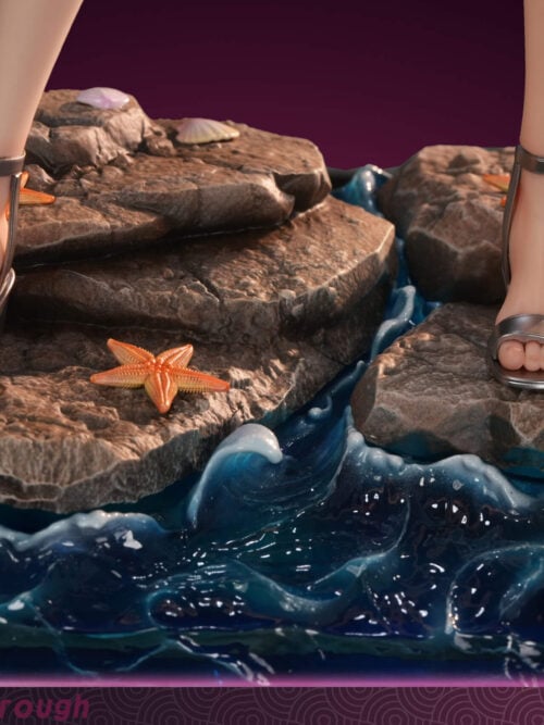 Front view of the rock and wave display base with silver sandals, sculpted shells, an orange starfish, and blue water effects.