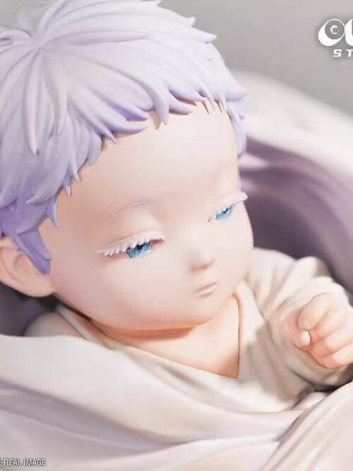 Close-up of the Baby Satoru Gojo figure showing short white hair, pale eyelashes, blue eyes, and one hand resting near the collar of the white swaddle.