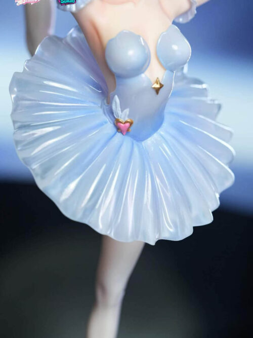 Close-up of the pale blue ballet bodice and pleated translucent tutu on the Odette Spessiva figure, showing the gold star emblem on the chest and pink heart-and-wing waist ornament.