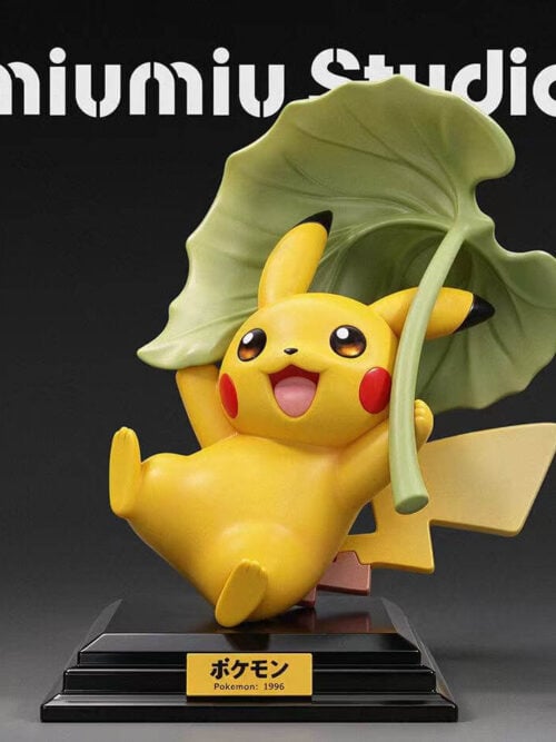 Front render of miumiu Studio Pikachu 30th Anniversary Vol. 12 figure holding a large green leaf above its head on a stepped black base with a Pokemon 1996 nameplate.