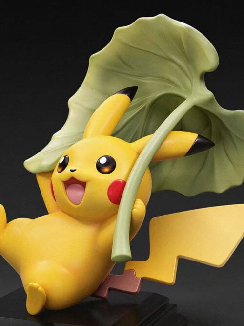 Angled render of the Pikachu 30th Anniversary Vol. 12 figure leaning back while holding a green leaf overhead with its lightning bolt tail extended behind.