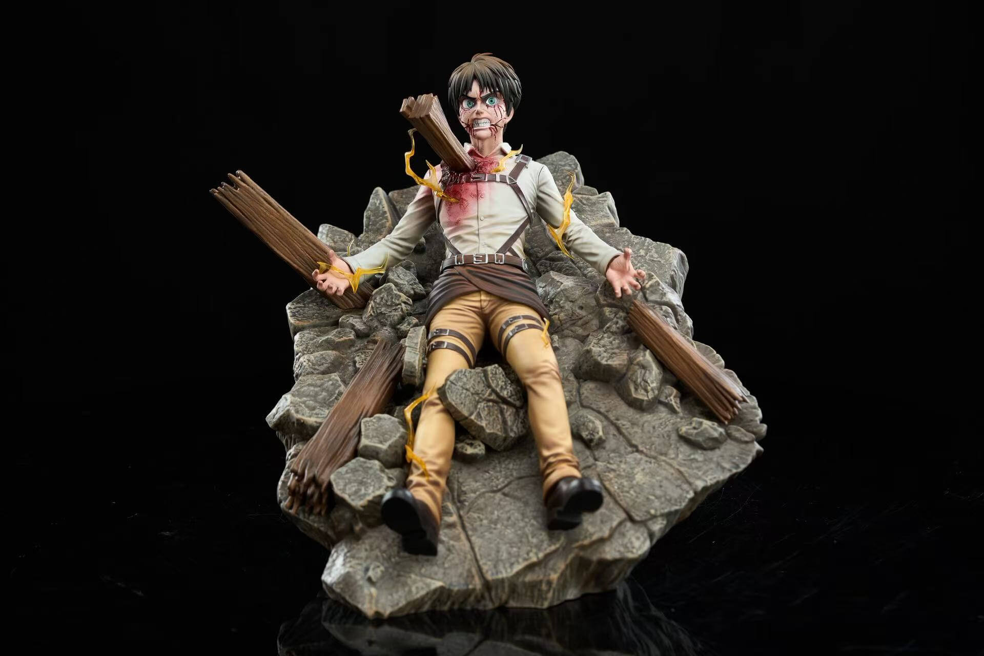 Eren Jaeger Bursting from the Ruins Statue Front View Front view of the KX Studio Eren Jaeger Bursting from the Ruins statue lying on a sloped rocky rubble base with splintered wooden beams, a beam impaling his chest, and yellow lightning effects.