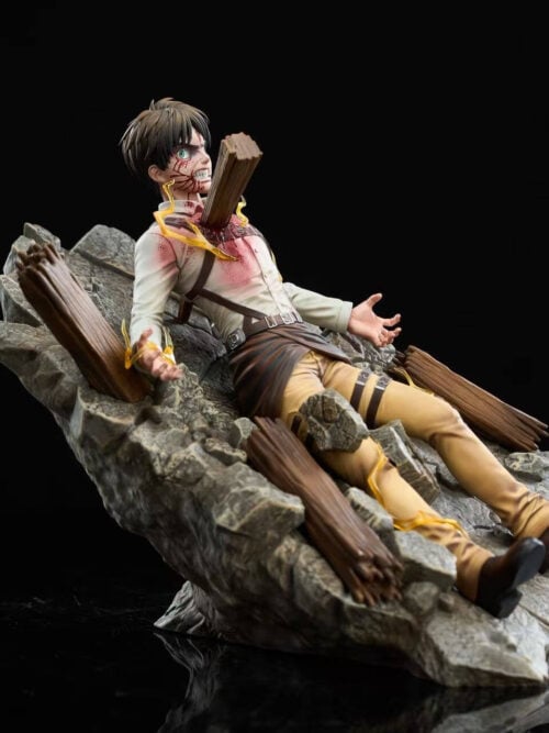 Front-right three-quarter view of the Eren Jaeger statue reclined across cracked rock and broken wooden beams with yellow lightning effects along his body.