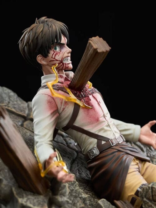 Medium shot from the right side showing Eren Jaeger's head, torso, outstretched arms, harness belts, impaled wooden beam, and rocky rubble base.